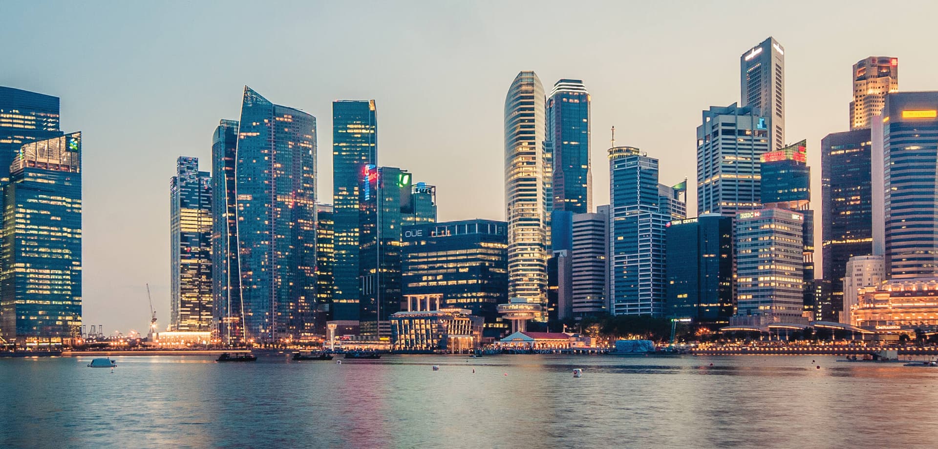 Office towers of the Central Business District from Marina Bay at dusk