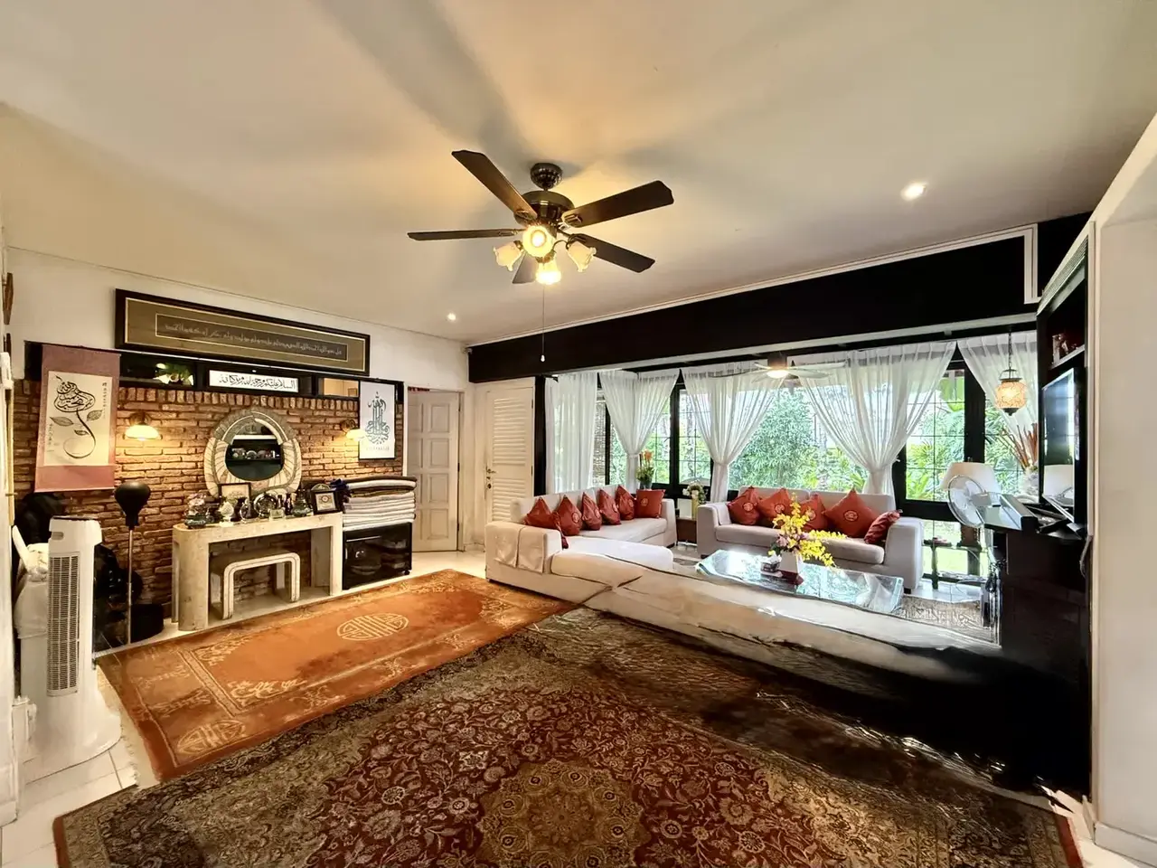 Living room with fireplace and garden windows