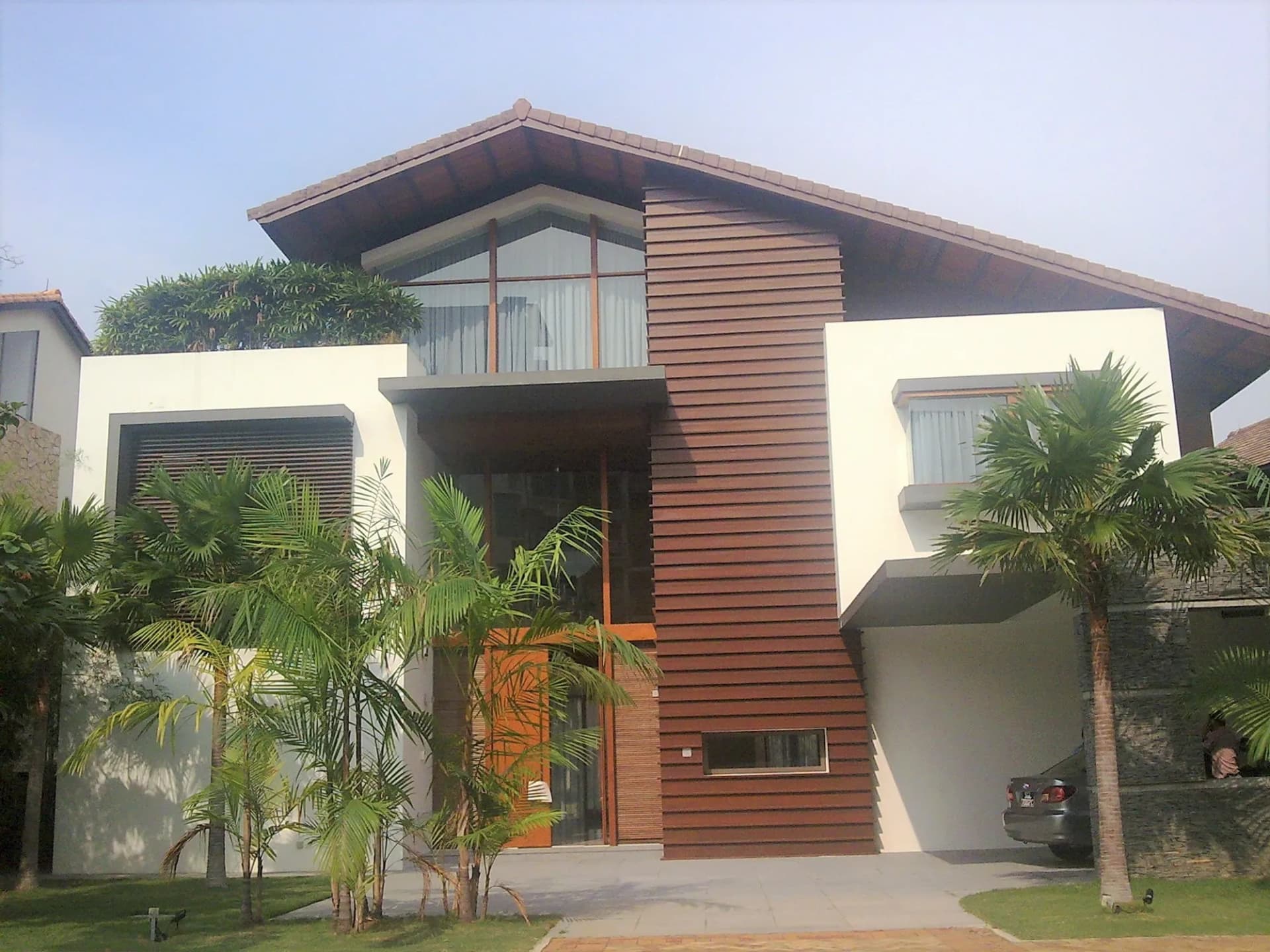 168 Ocean Drive, a bungalow with a pitched timber roof and tropical garden
