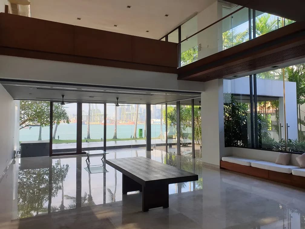 Double-height living and dining room facing the sea