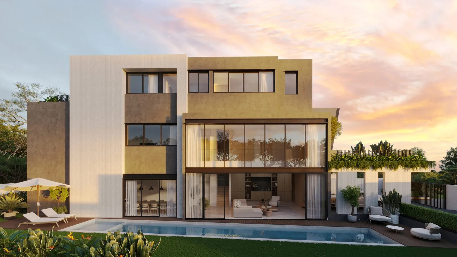 The bungalow's pool and double-height glass living room at dusk