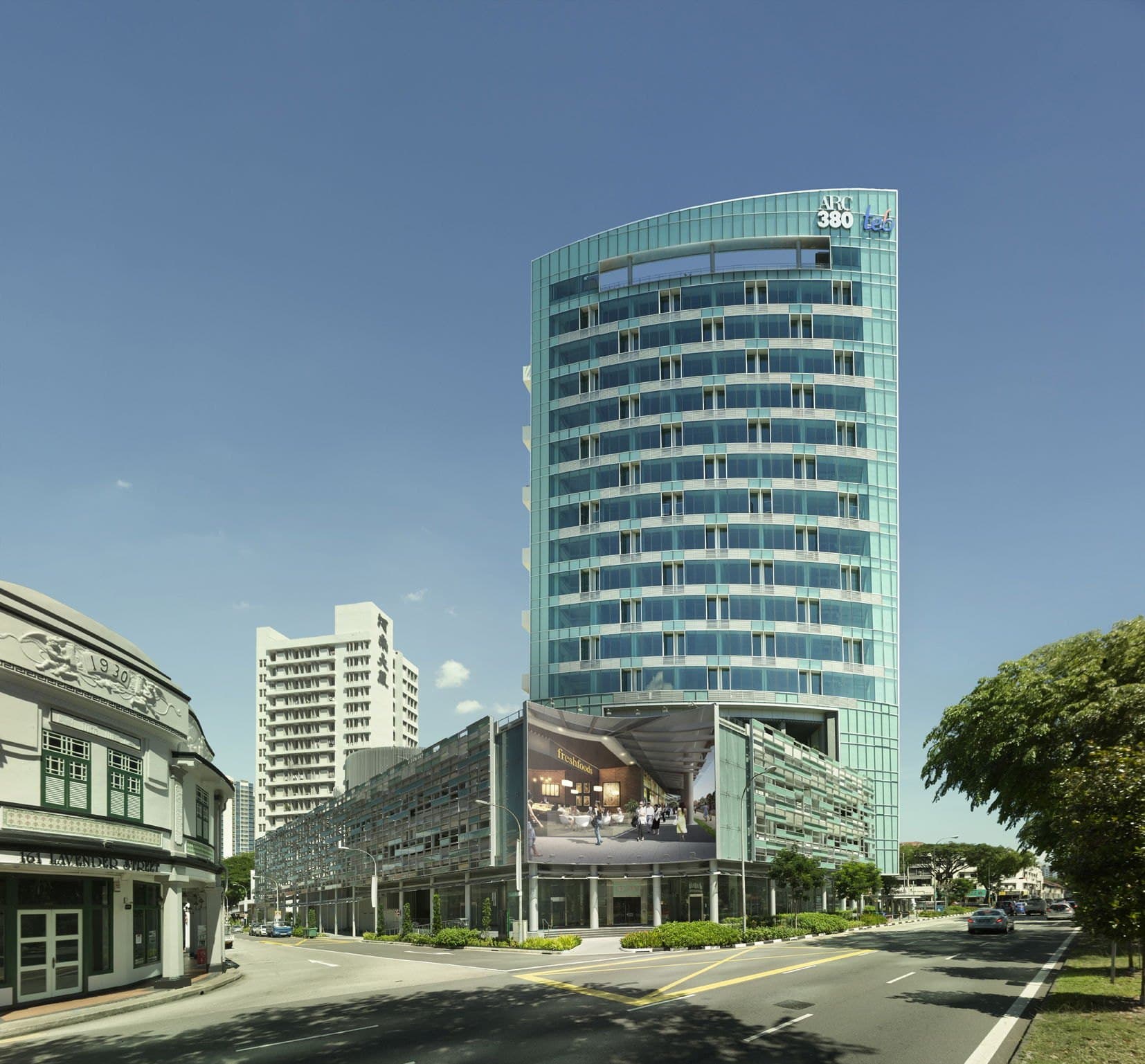 ARC 380, a curved glass office tower over a podium at the corner of Jalan Besar and Lavender Street